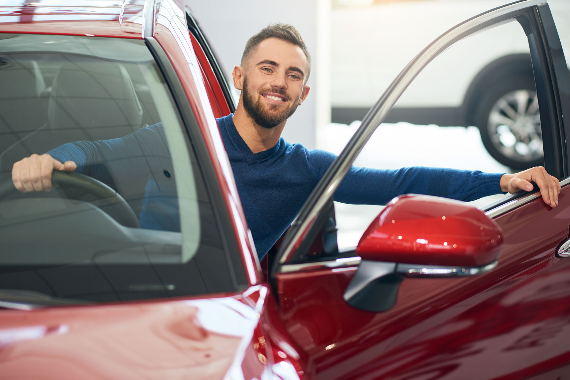 A man checks out a used car for sale