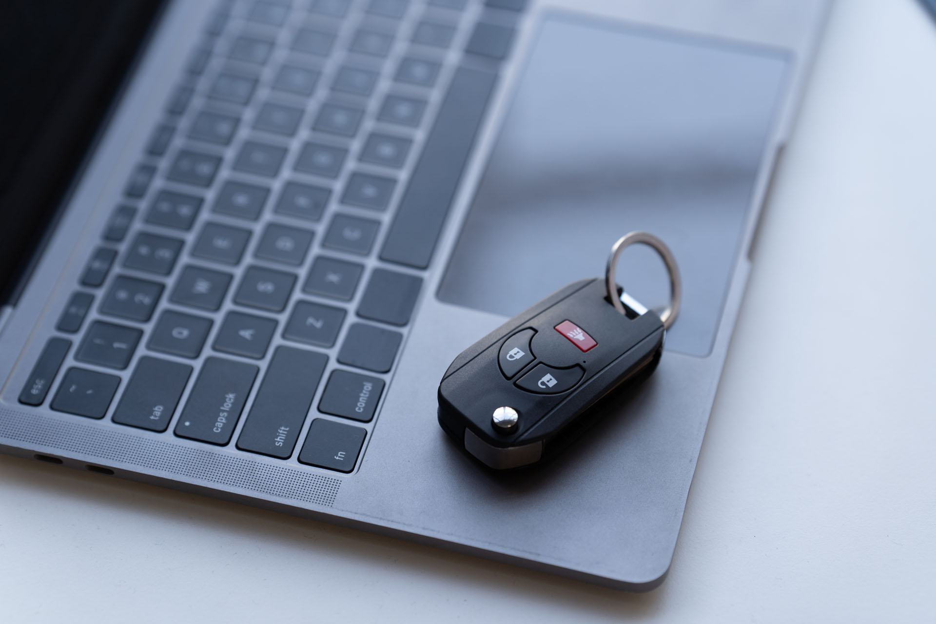 Car keys placed on a laptop as a user applies for auto financing