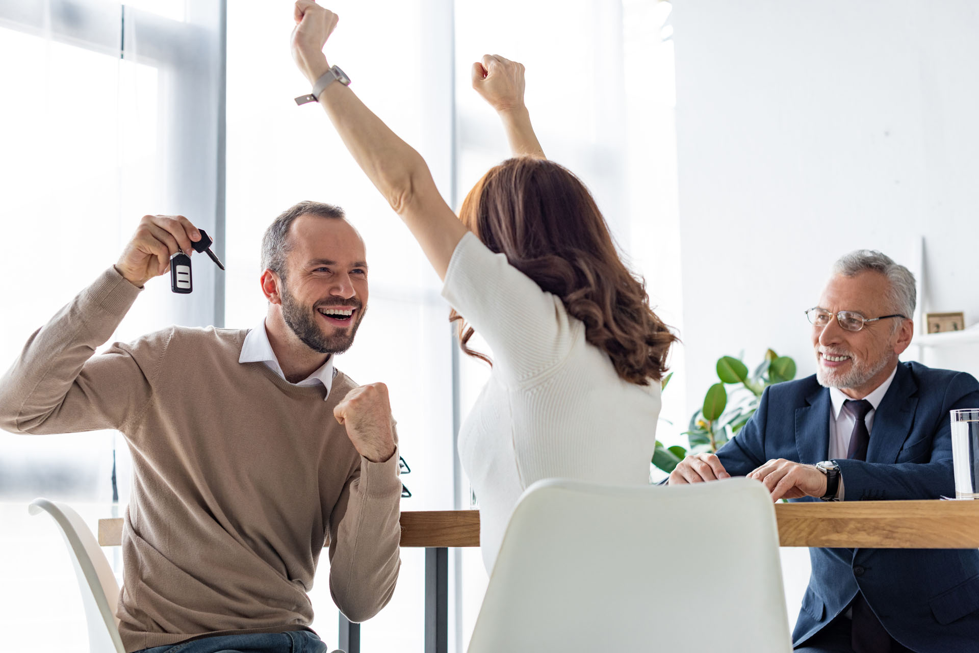 A couple celebrates getting a used car