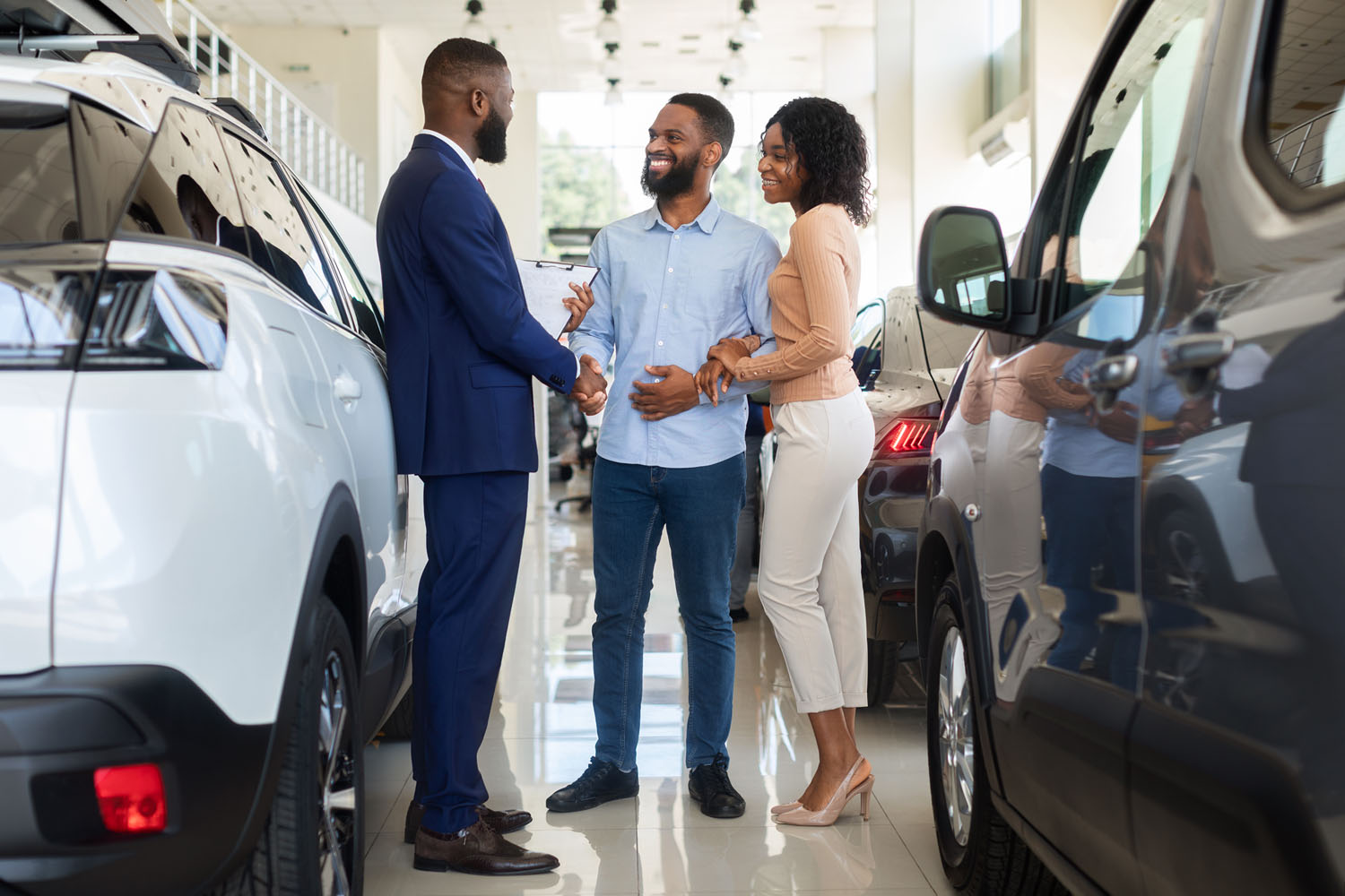 A couple speaking with a car salesperson