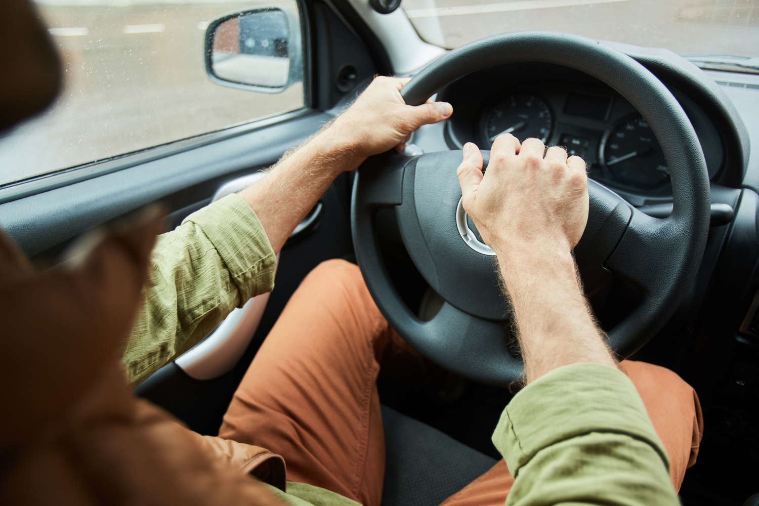 A person test driving a used car