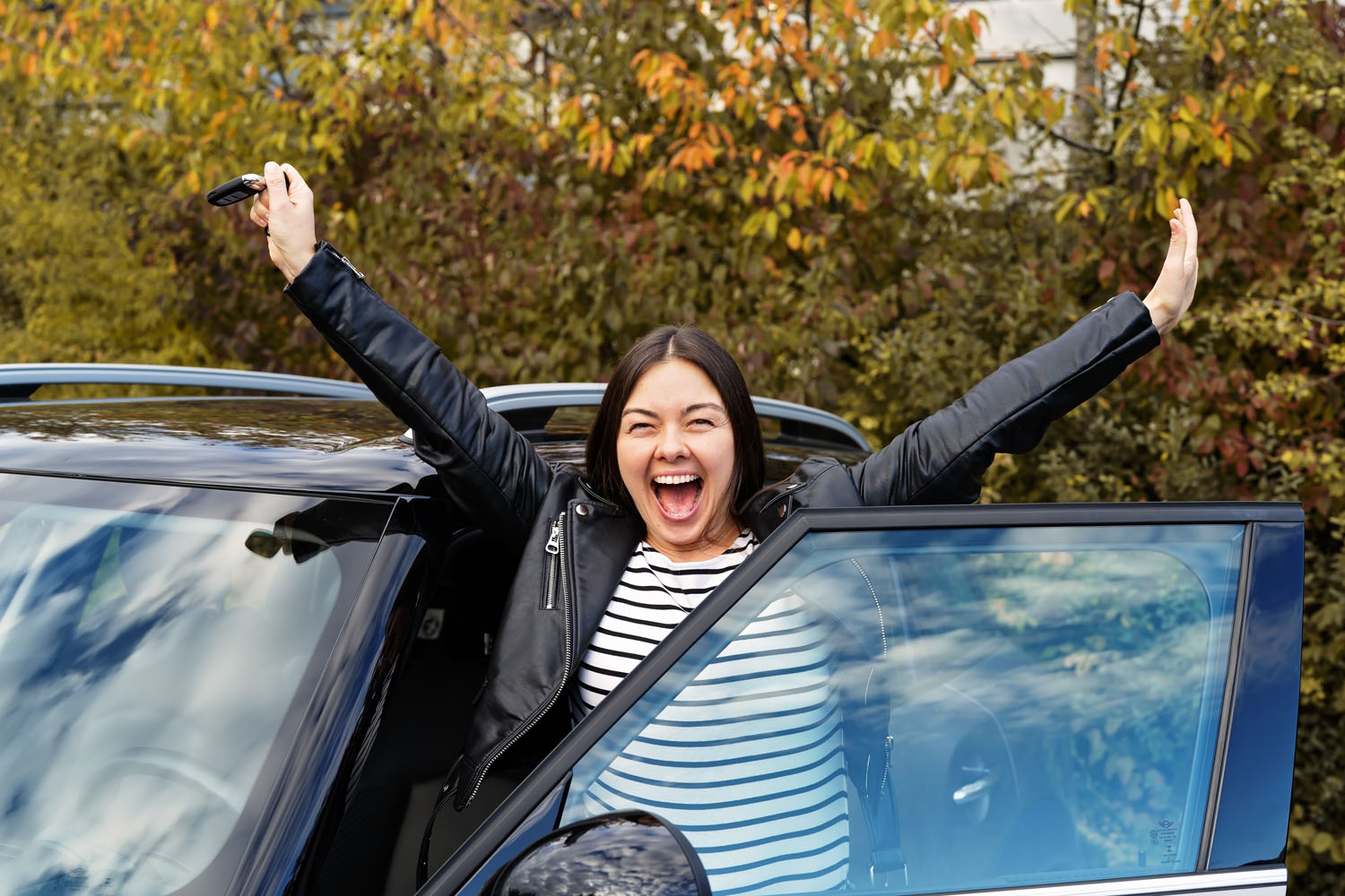 A woman celebrates getting a used car