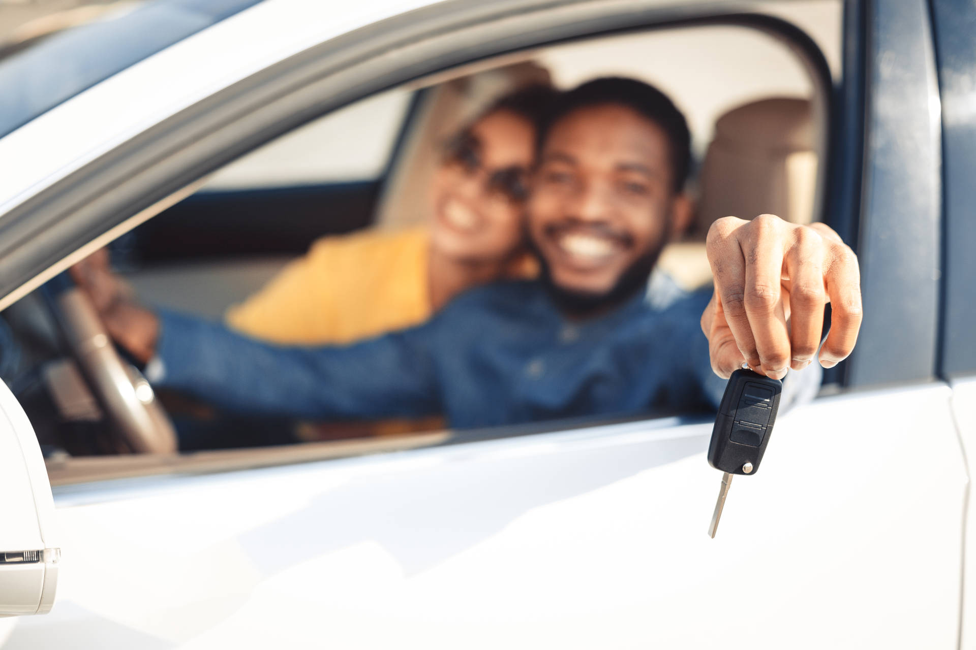 A couple smiling after they purchased their used car