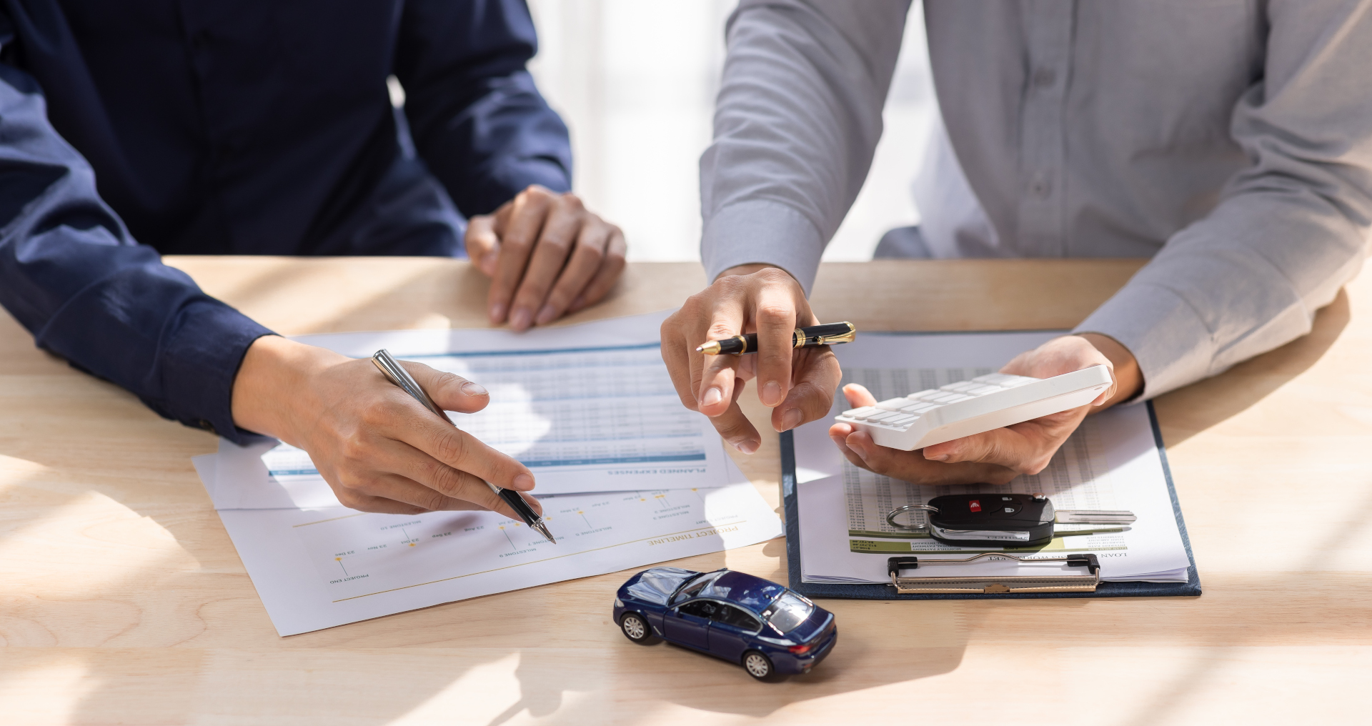 A car buyer and salesperson discuss terms 