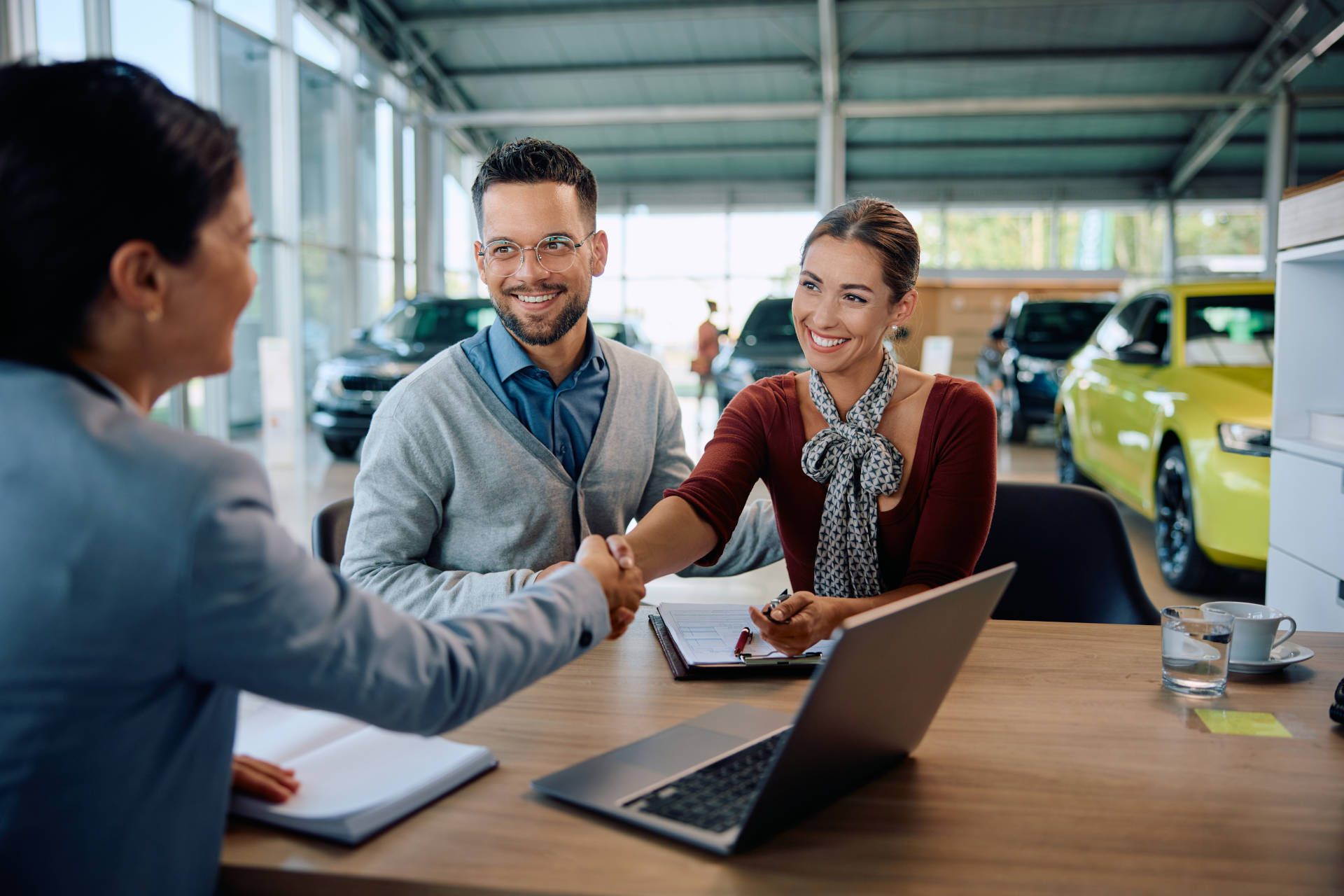 A couple signing for a car loan.