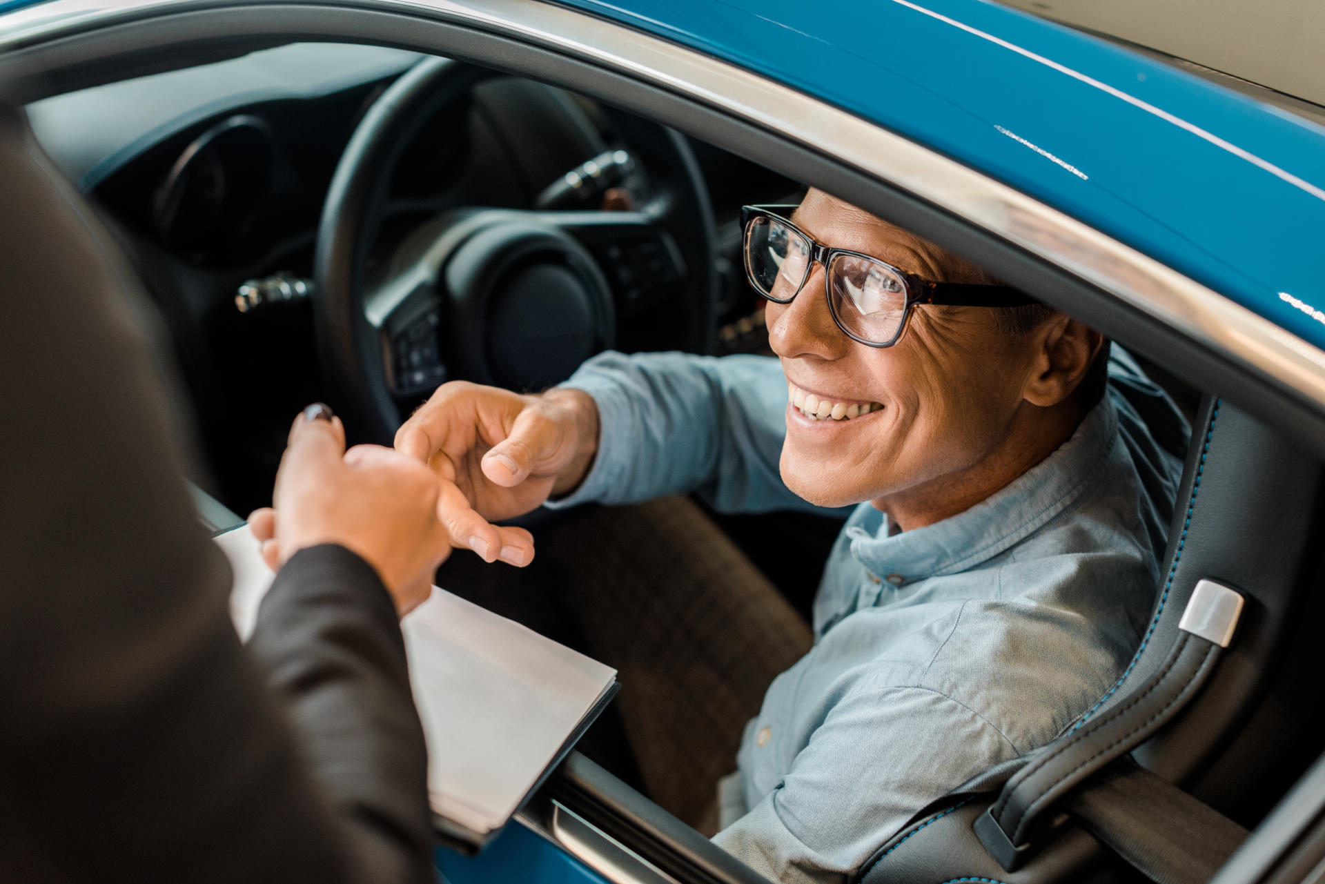 A man look at a used car he's interested in buying