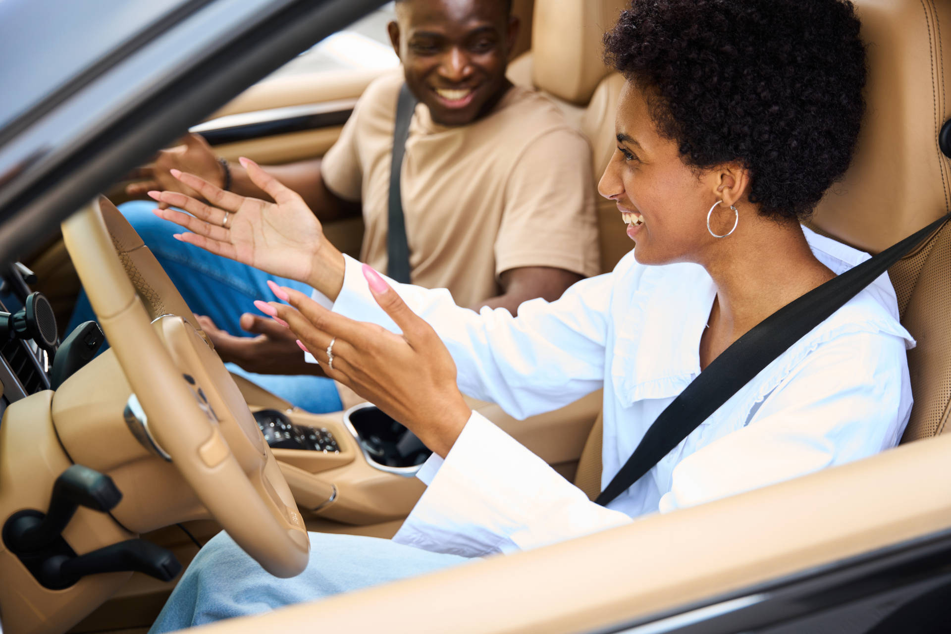 A smiling couple sitting in a car