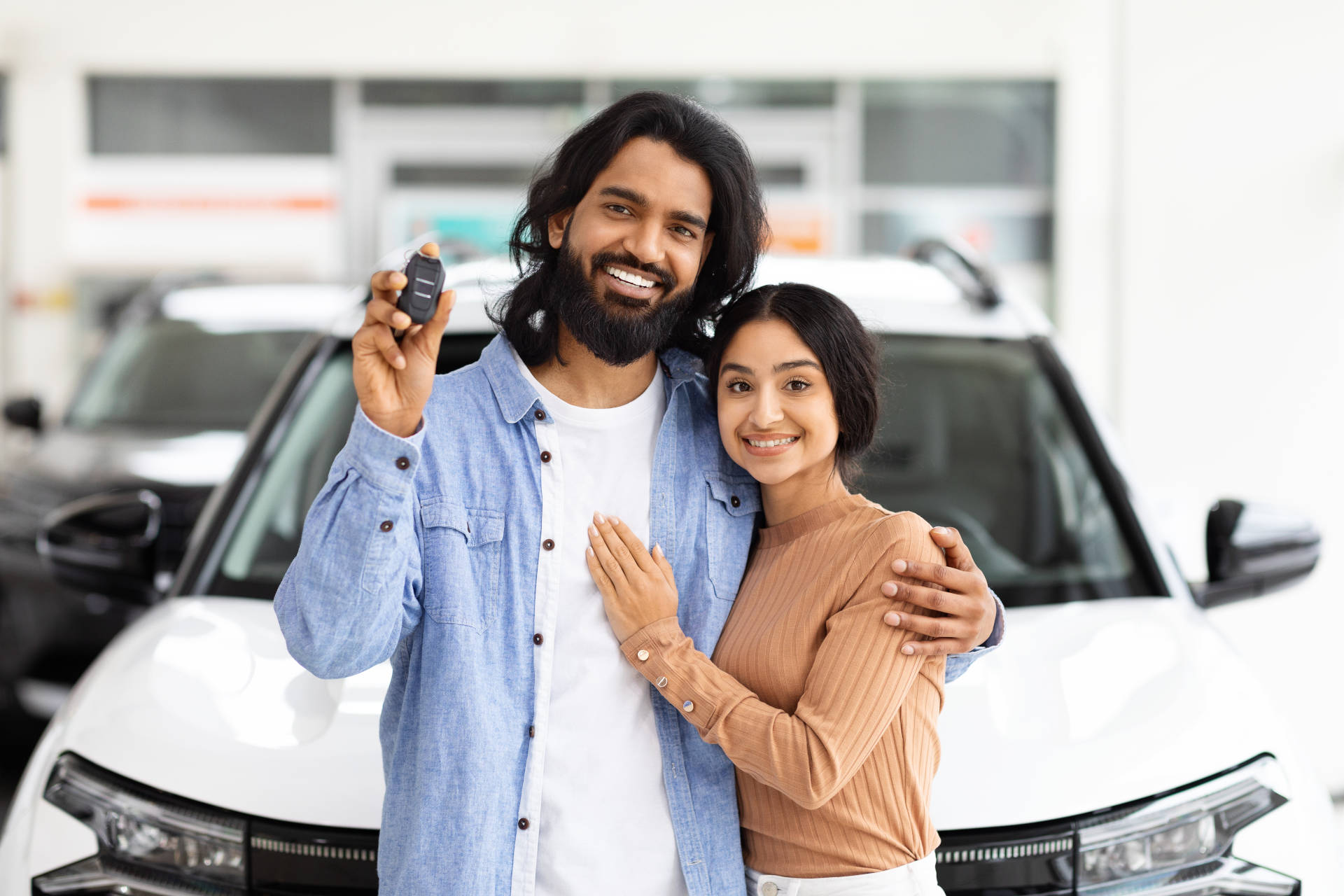 A couple celebrates their car purchase